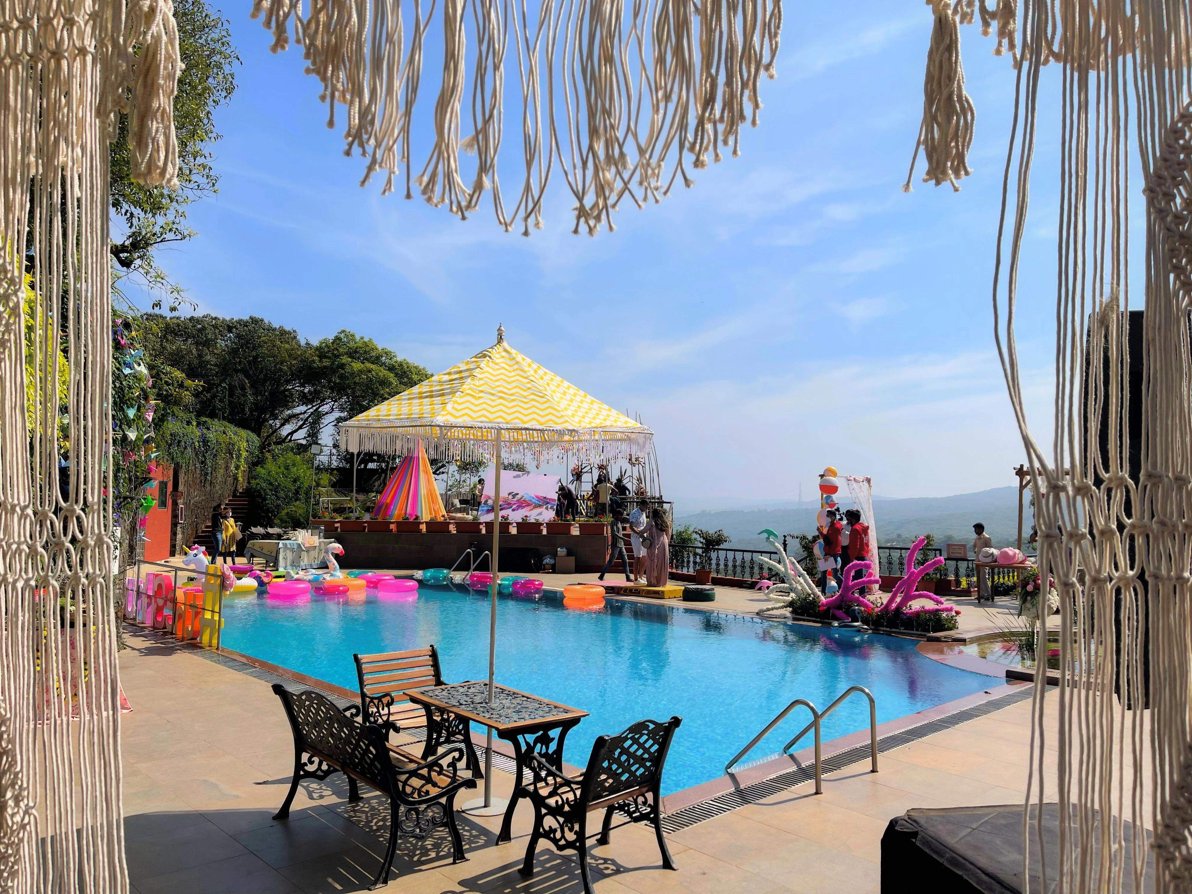 Pool deck wedding event with festive decorations and poolside seating at Ramsukh Resort, Mahabaleshwar.